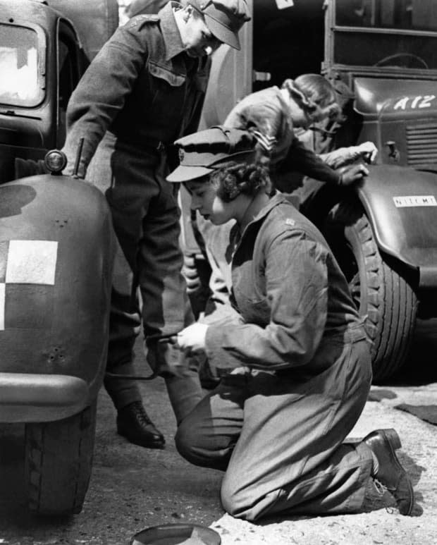 Princess Elizabeth changes the wheel of her car during training at an A.T.S training center in Southern England in 1945.<p><a href="https://www.gettyimages.com/detail/1230850822" rel="nofollow noopener" target="_blank" data-ylk="slk:-/Getty Images;elm:context_link;itc:0;sec:content-canvas" class="link ">-/Getty Images</a></p>