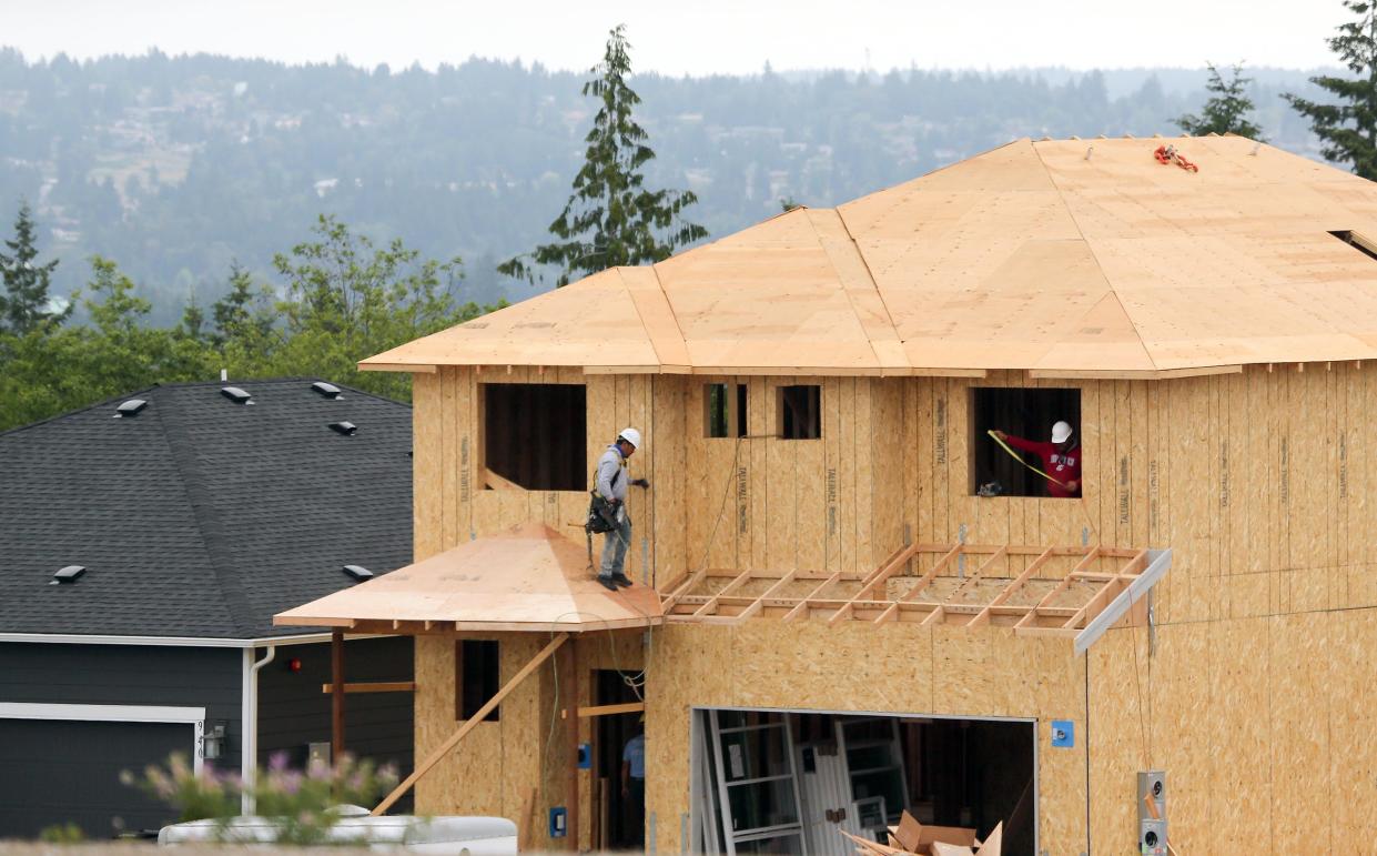 Construction crew members works on the second floor of a home in Soundview Estates in Bremerton on Thursday, June 3, 2021. 	