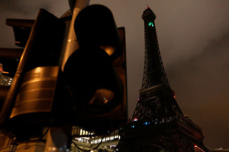 Traffic light and a replica of the Eiffel Tower are seen outside the Parisian Macao, during a power outage, after Typhoon Hato hit in Macau, China August 24, 2017. REUTERS/Tyrone Siu