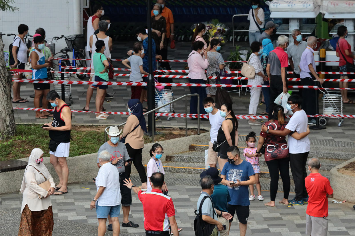 People wait in queue to buy durian on 24 June. (PHOTO: Getty Images)