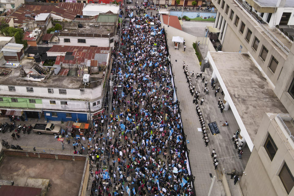 Supporters of the Seed Movement party protest outside Guatemala's Attorney General's office building in Guatemala City, Thursday, July 13, 2023. The Constitutional Court, which is the country's highest tribunal, granted a preliminary injunction to the Seed Movement, blocking its suspension from the runoff presidential election. (AP Photo/Santiago Billy)