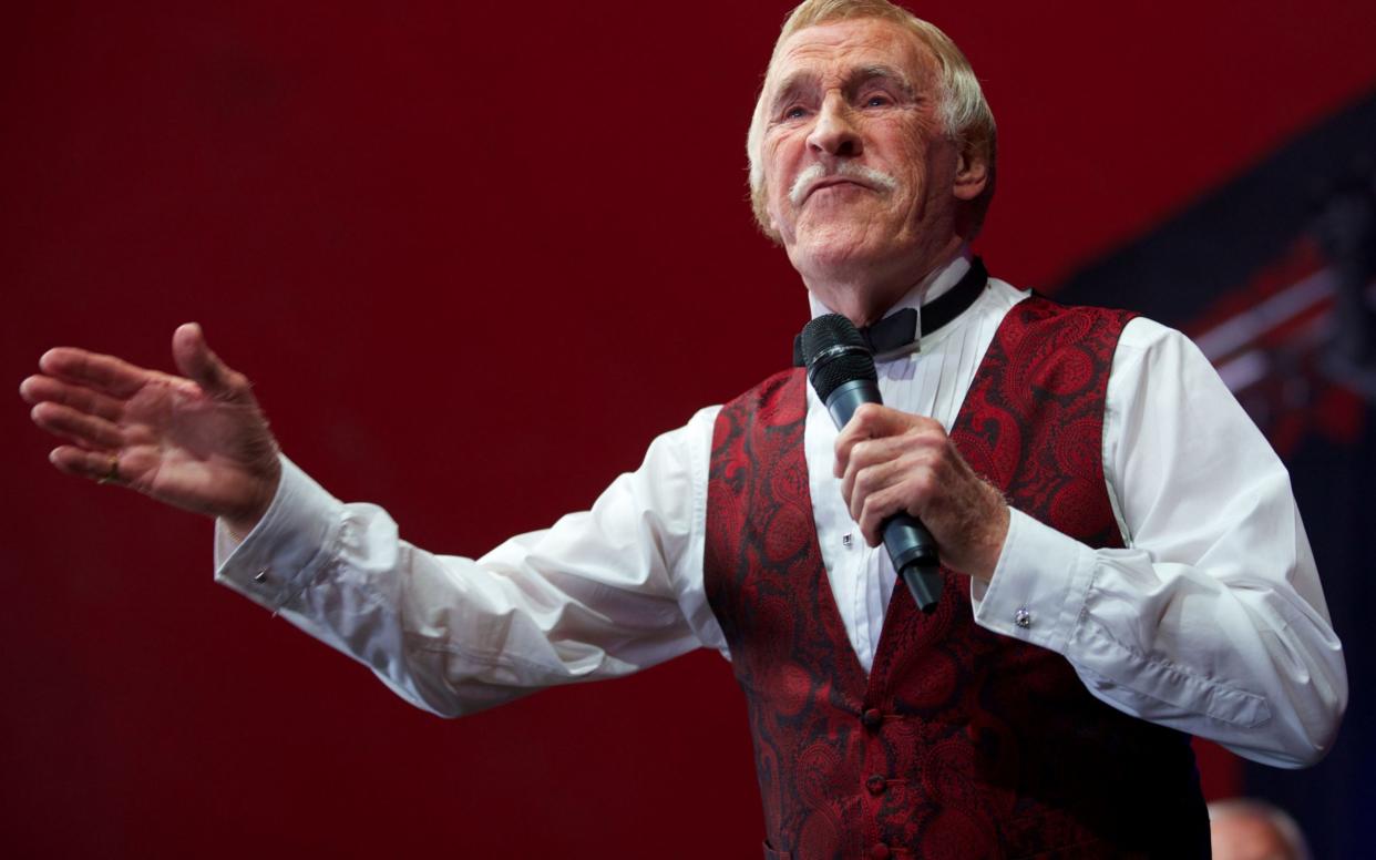 Bruce Forsyth gesturing to the crowd while performing on the Avalon stage on the fifth day of the Glastonbury Festival of Contemporary Performing Arts near Glastonbury - AFP