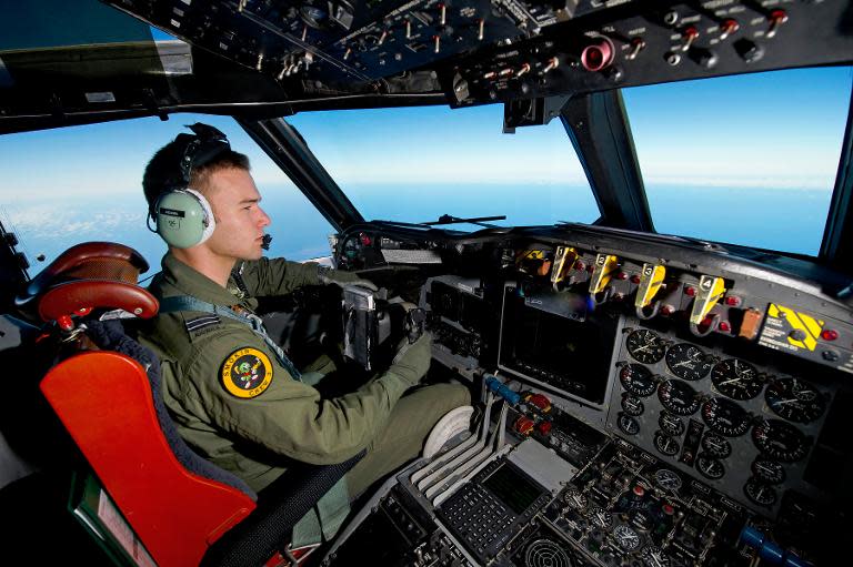 A handout photo taken on March 19, 2014 shows Royal Australian Air Force pilot Flight Lieutenant Russell Adams from 10 Squadron, flying his AP-3C Orion over the Southern Indian Ocean during the search for missing Malaysian Airlines flight MH370