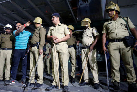 Police stand guard outside a multiplex during a protest against the release of the upcoming Bollywood movie "Padmaavat" in Ahmedabad, January 23, 2018. REUTERS/Amit Dave