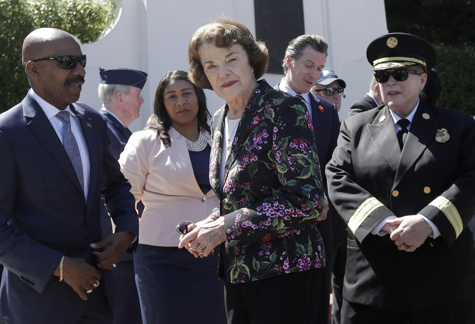 FILE - Kenneth C. Johnson of the National Cemetery Administration, from left, stands with San Francisco mayoral candidate and Board of Supervisors President London Breed, Sen. Dianne Feinstein, D-Calif., California Lt. Gov. Gavin Newsom and San Francisco Fire Chief Joanne Hayes-White at a Memorial Day Commemoration at San Francisco National Cemetery in the Presidio in San Francisco, May 28, 2018. Feinstein's ongoing medical struggles have raised a sensitive political question with no easy answer: Who would California Democratic Gov. Newsom pick to replace her if the seat became vacant? (AP Photo/Jeff Chiu, File)