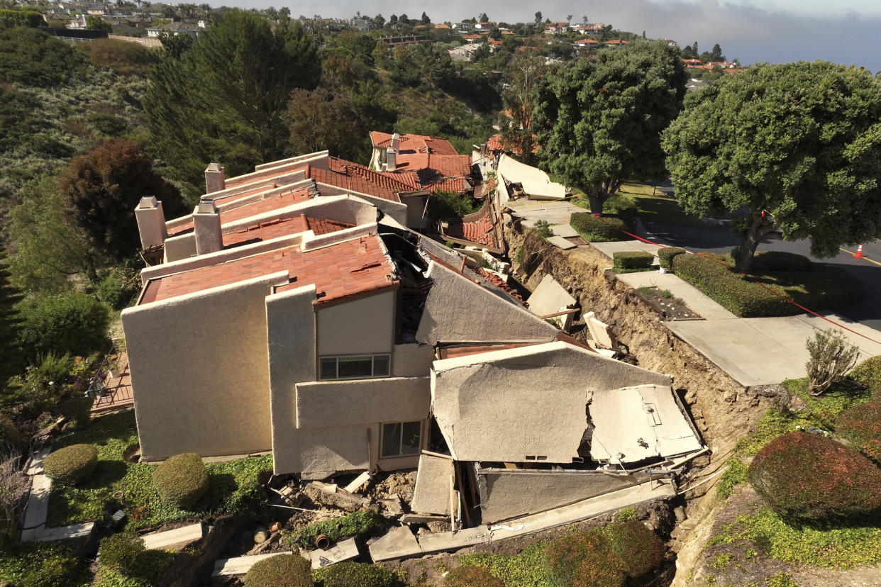 This photo shot with a drone shows damage from earth movement to a property in Rolling Hills Estates, Calif. Monday, July 10, 2023. The homes in the Los Angeles County city of Rolling Hills Estates were hastily evacuated by firefighters Saturday when cracks began appearing in structures and the ground. (Ted Soqui via AP)