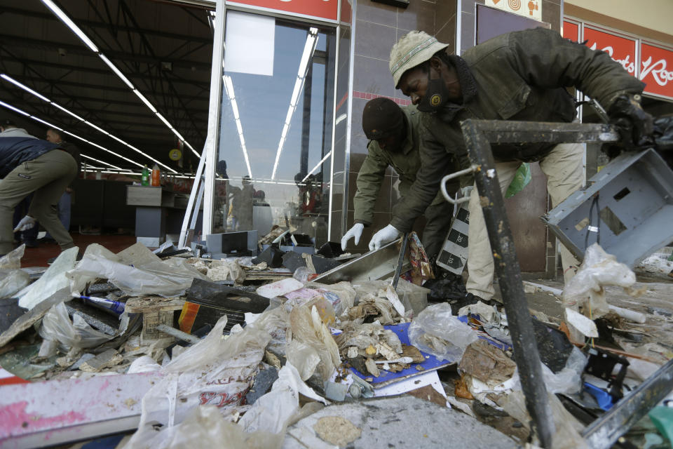 Clean up operations get underway at a shopping centre in Vosloorus, near Johannesburg, Thursday, July 15, 2021. South African police and the army are struggling to bring order to impoverished areas of South Africa rocked by weeklong unrest and days of looting sparked by the imprisonment last week of ex-President Jacob Zuma. (AP Photo/Themba Hadebe)