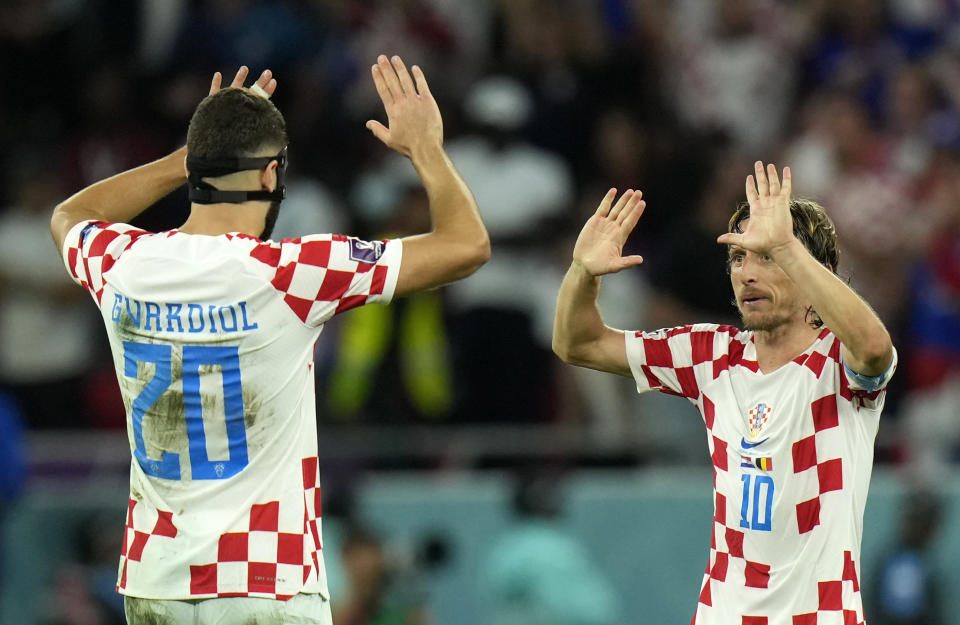 Croatia's Luka Modric, right, and Croatia's Josko Gvardiol celebrate at the end of the World Cup group F soccer match between Croatia and Belgium at the Ahmad Bin Ali Stadium in Al Rayyan, Qatar, Thursday, Dec. 1, 2022. (AP Photo/Francisco Seco)