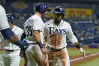 Tampa Bay Rays' Yandy Diaz celebrates his three-run home run off Toronto Blue Jays starting pitcher Robbie Ray with Kevin Kiermaier (39) during the fifth inning of a baseball game Monday, Sept. 20, 2021, in St. Petersburg, Fla. (AP Photo/Chris O'Meara)