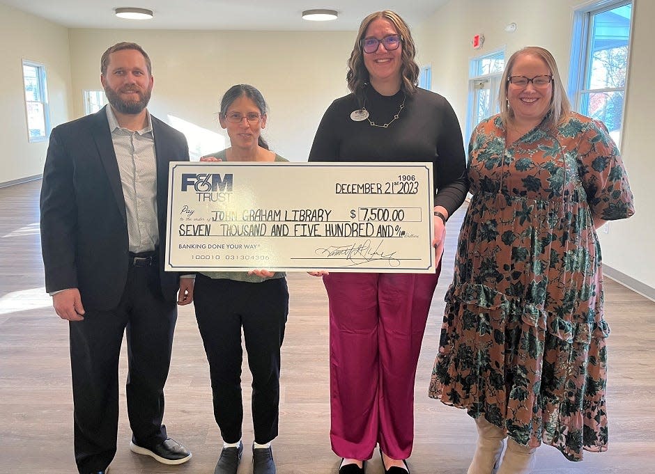 John Graham Library Director Mary Schoedel accepts a check for $7,500 from F&M Trust Wealth Advisor Adam Hollinger, Newville Community Office Manager Shelby Yinger, and Regional Market Manager Summer Franzoni.