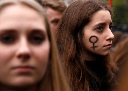 A woman looks on as people gather to protest against plans for a total ban on abortion in front of the ruling party Law and Justice (PiS) headquarters in Warsaw, Poland. REUTERS/Kacper Pempel