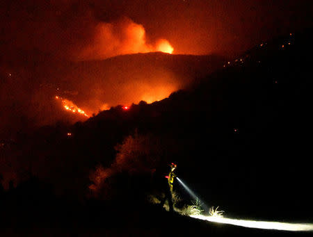 Firefighters keep watch on the Thomas wildfire in the hills and canyons outside Montecito, California, U.S., December 16, 2017. REUTERS/Gene Blevins
