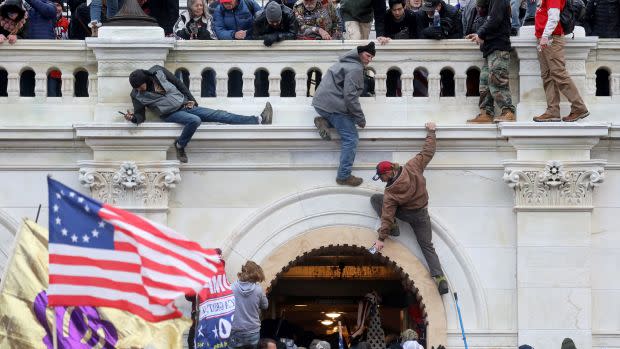 Trump supporters scale the walls of the US capitol building