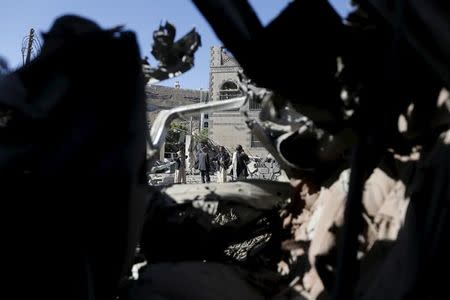 People stand at the site of a Saudi-led air strike in Yemen's capital Sanaa February 27, 2016. REUTERS/Khaled Abdullah