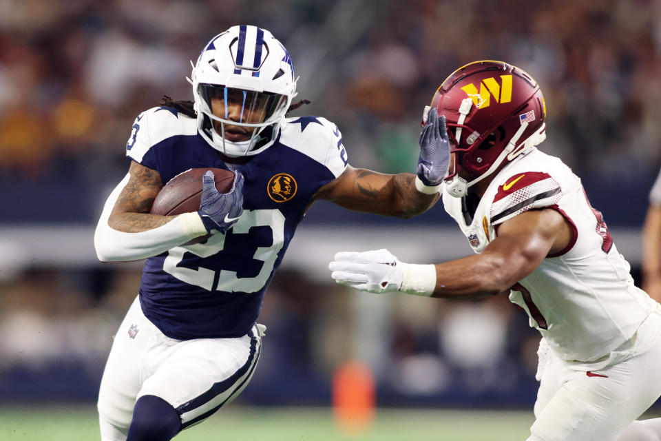 Nov 23, 2023; Arlington, Texas, USA; Dallas Cowboys running back Rico Dowdle (23) runs the ball in the first quarter against <a class="link " href="https://sports.yahoo.com/nfl/teams/washington/" data-i13n="sec:content-canvas;subsec:anchor_text;elm:context_link" data-ylk="slk:Washington Commanders;sec:content-canvas;subsec:anchor_text;elm:context_link;itc:0">Washington Commanders</a> linebacker <a class="link " href="https://sports.yahoo.com/nfl/players/32832" data-i13n="sec:content-canvas;subsec:anchor_text;elm:context_link" data-ylk="slk:Khaleke Hudson;sec:content-canvas;subsec:anchor_text;elm:context_link;itc:0">Khaleke Hudson</a> (47) at AT&T Stadium. Mandatory Credit: Tim Heitman-USA TODAY Sports