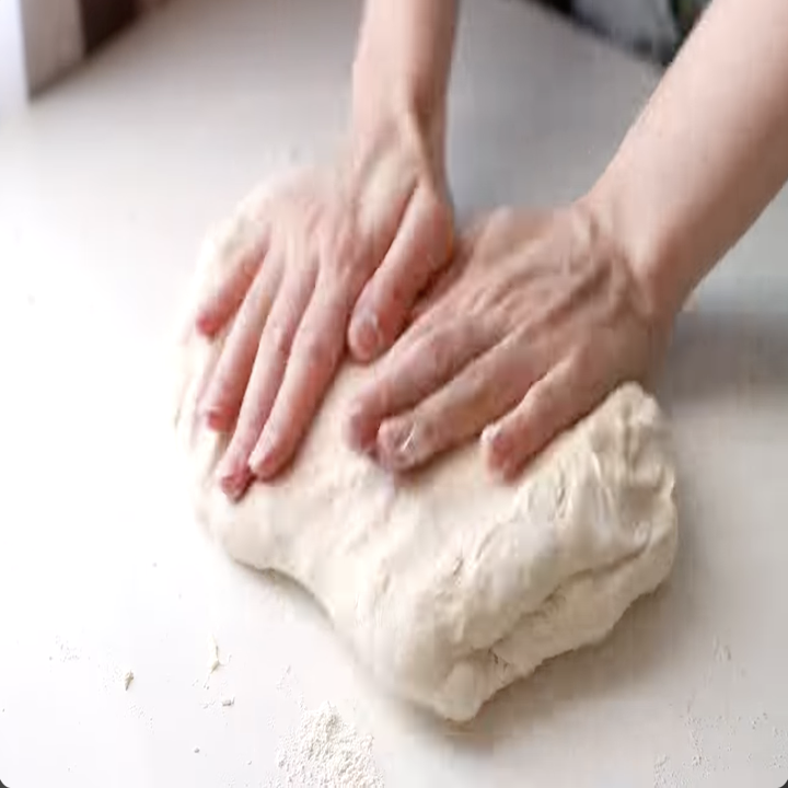 woman kneading bread dough