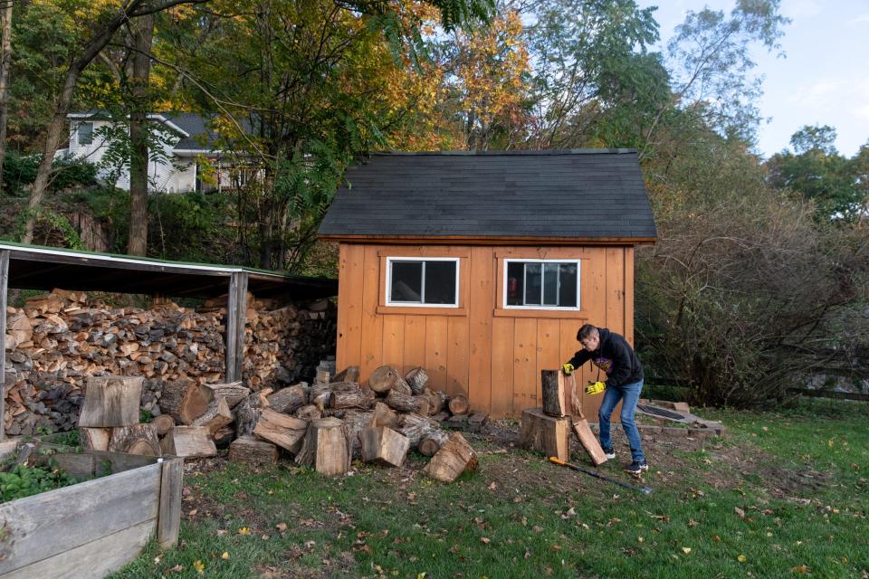 Tobi chops wood in his backyard, which he says helps with stress relief.