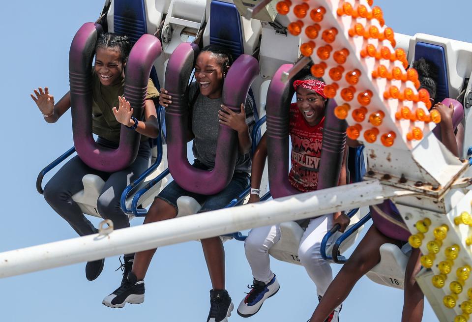 Young fair-goers scream from a swinging thrill ride on closing day of the Indiana State Fair at the State Fairgrounds in Indianapolis, Sunday, Aug. 19, 2018.