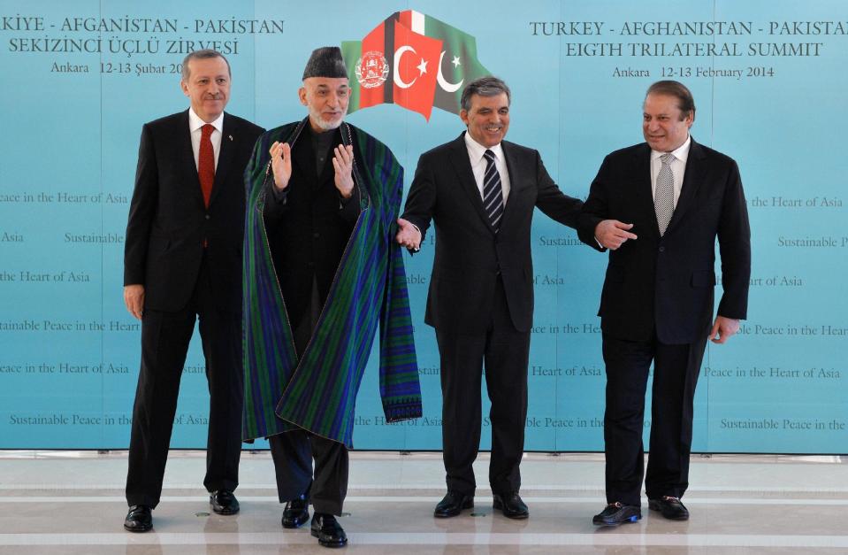 In this photo released by the Turkish Presidency Press Office, Turkish Abdullah Gul, second right, Turkish Prime Minister Recep Tayyip Erdogan, left, Afghan President Hamid Karzai, second left, and Pakistan Prime Minister Nawaz Sharif pose for cameras after their meeting in Ankara, Turkey. Karzai and Sharif are in Turkey for the 8th Afghanistan-Pakistan-Turkey Trilateral Summit.(AP Photo/Murat Cetinmuhurdar, Turkish Presidency Press Office, HO)