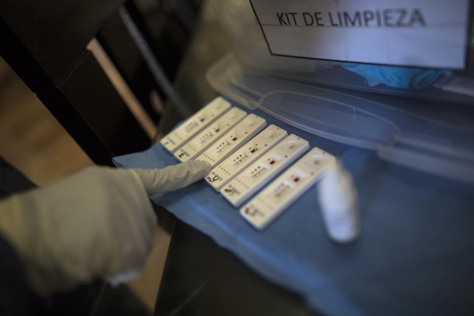 FILE - In this April 15, 2020 file photo, a healthcare worker testing for the new coronavirus monitors the results of antibody tests, inside a home in Lima, Peru. Peru imported millions of COVID-9 antibody tests to detect infections, even though they are not designed to identify active cases. Some have been banned from distribution in the United States after being found faulty. (AP Photo/Rodrigo Abd, File)