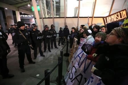 Protesters gather outsideTerminal 4 at JFK airport in opposition to U.S. president Donald Trump's proposed ban on immigration in Queens. REUTERS/Stephen Yang