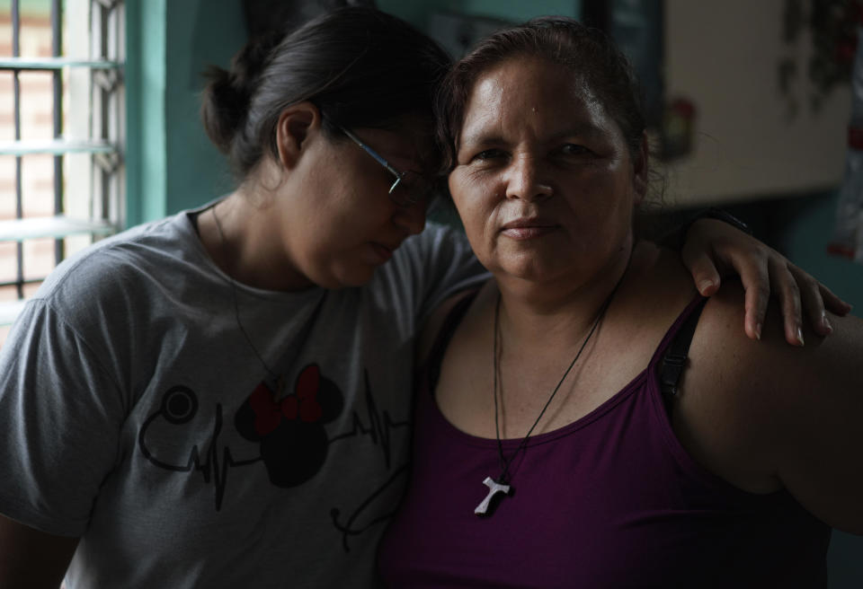 Cindy, left, leans on her mom, Aracely, who supported her when in 2014 she was imprisoned for an obstetric emergency, in San Salvador, El Salvador, on Friday, May 20, 2022. She and her son live with her parents as she resumes her tourism studies. Because it’s been hard for Cindy to find work, she and her mom make hand craft piñatas for children, selling them out of their home. (AP Photo/Jessie Wardarski)