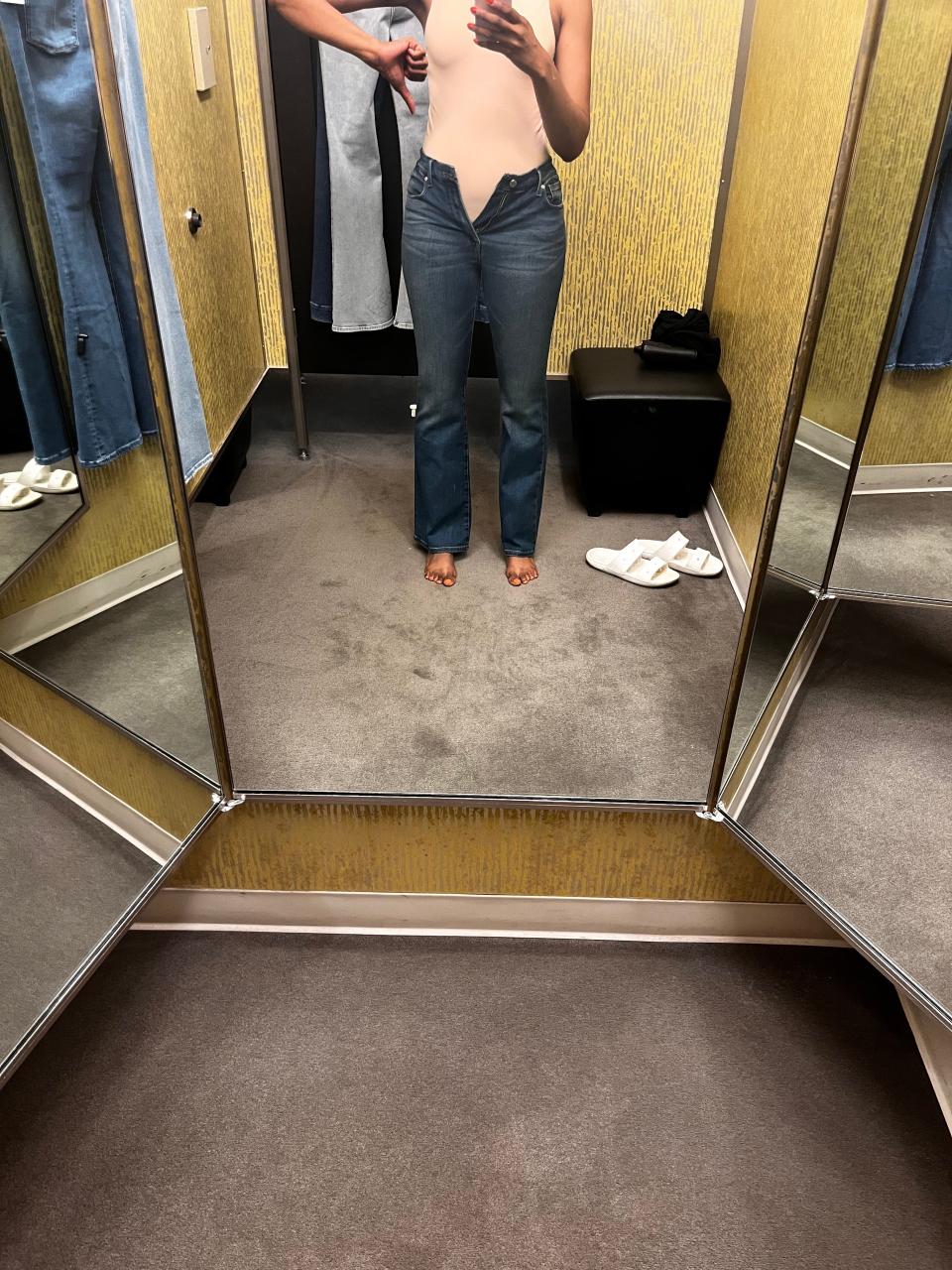Author Joi-Marie McKenzie trying on jeans in a Nordstrom dressing room.