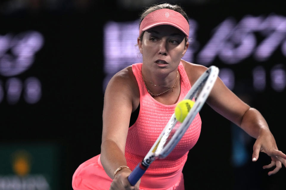 Danielle Collins of the U.S. plays a backhand return to Iga Swiatek of Poland during their second round match at the Australian Open tennis championships at Melbourne Park, Melbourne, Australia, Thursday, Jan. 18, 2024. (AP Photo/Andy Wong)