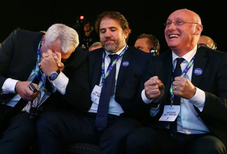 President of the French bid Claude Atcher (L), French rugby union federation (FFR) vice-president Serge Simon (C) and French rugby president Bernard Laporte react as France is named to host the 2023 Rugby World Cup, in London, on November 15, 2017