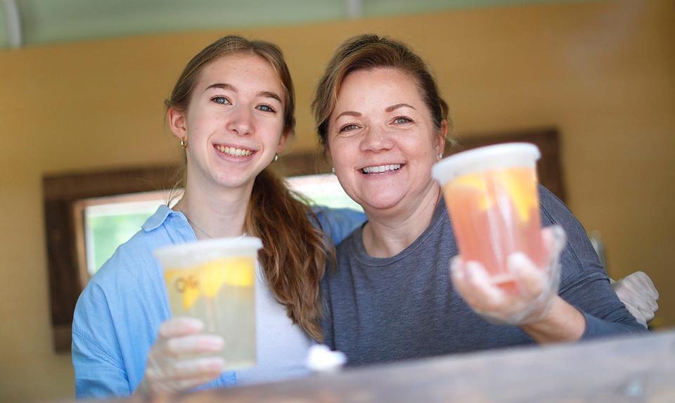 Pucker Up Lemonade Co.'s Jordiss Fabrowski, 16, of Halifax, left, sells the lemonade out of a former horse trailer with her mother, Renee, right, Monday, June 19, 2023.