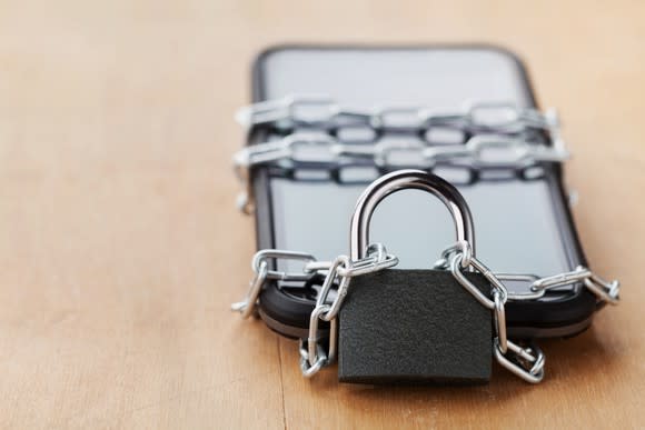 Smartphone wraped in chains and a lock.