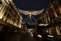 The Regent Street Christmas lights entitled 'The Spirit of Christmas' stand illuminated after being switched on yesterday without a ceremony as shops on the street lie temporarily closed due to England's second coronavirus lockdown, in London, Sunday, Nov. 15, 2020. This week saw Britain on Wednesday become the fifth country in the world to record more than 50,000 coronavirus-related deaths and on Thursday to record 33,470 people testing positive for COVID-19, the highest daily number of new cases since the virus first struck. (AP Photo/Matt Dunham)