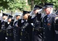 Firefighters and police salute during Taps at the 9/11 Memorial during ceremony marking the 12th Anniversary of the attacks on the World Trade Center in New York September 11, 2013. REUTERS/David Handschuh/Pool