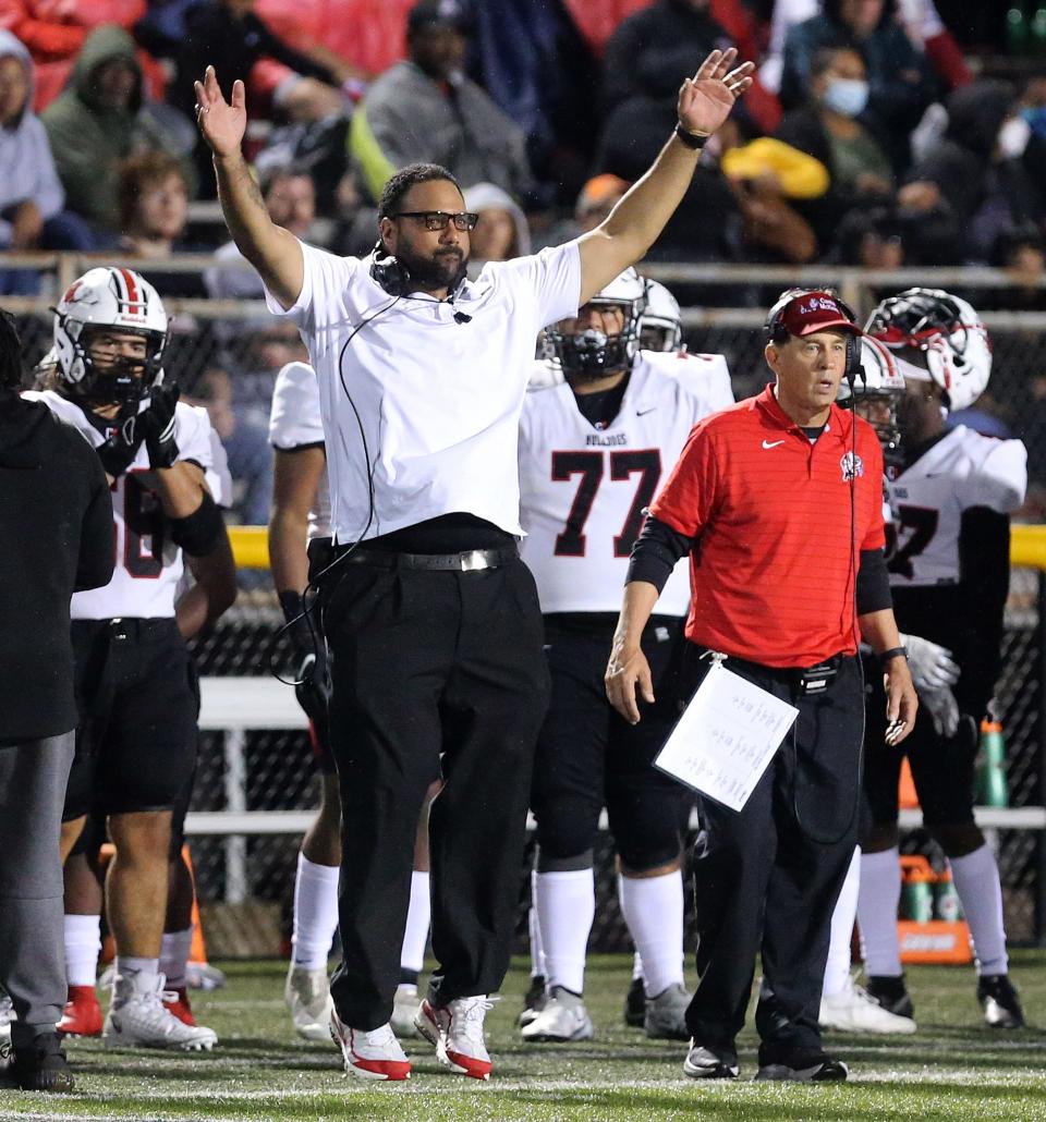 Canton McKinley coach Antonio Hall reacts during a game in 2021. At right is defensive coordinator Joe Tresey.