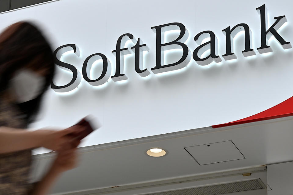 A woman walks past a SoftBank telecommunications store along a street in Tokyo on June 23, 2020. - Japanese tech investment behemoth SoftBank Group said on June 23, 2020 it will sell T-Mobile shares worth over 21 billion USD as it sheds assets to shore up its financial health. (Photo by CHARLY TRIBALLEAU / AFP) (Photo by CHARLY TRIBALLEAU/AFP via Getty Images)