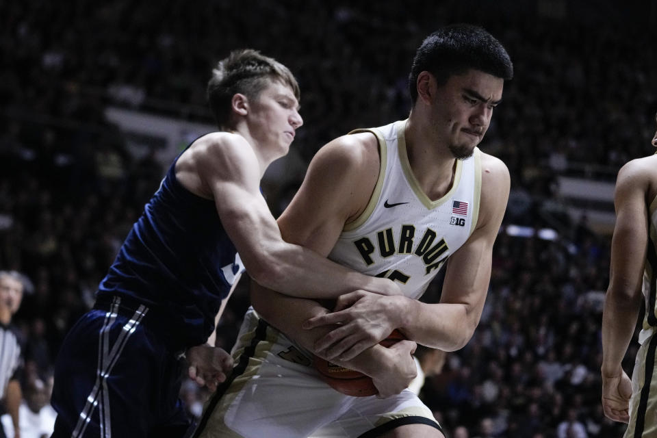 Purdue center Zach Edey (15) and Xavier forward Gytis Nemeiksa (50) fight for a rebound during the first half of an NCAA college basketball game in West Lafayette, Ind., Monday, Nov. 13, 2023. (AP Photo/Michael Conroy)