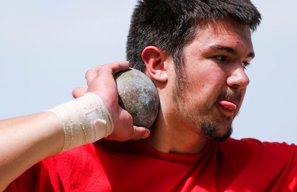 Jackson Cantwell spins around as he practices throwing a shotput during track and field practice at Nixa High School on Wednesday, April 24, 2024.