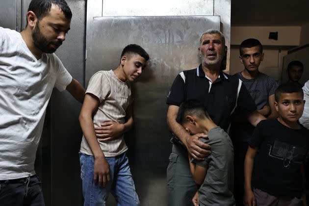 Palestinian relatives grieve as they wait Friday to receive the body of 21-year-old Qais Muhammad Zakarneh, who was killed during an Israeli military operation the day before in Qabatiyeh in northern occupied West Bank.