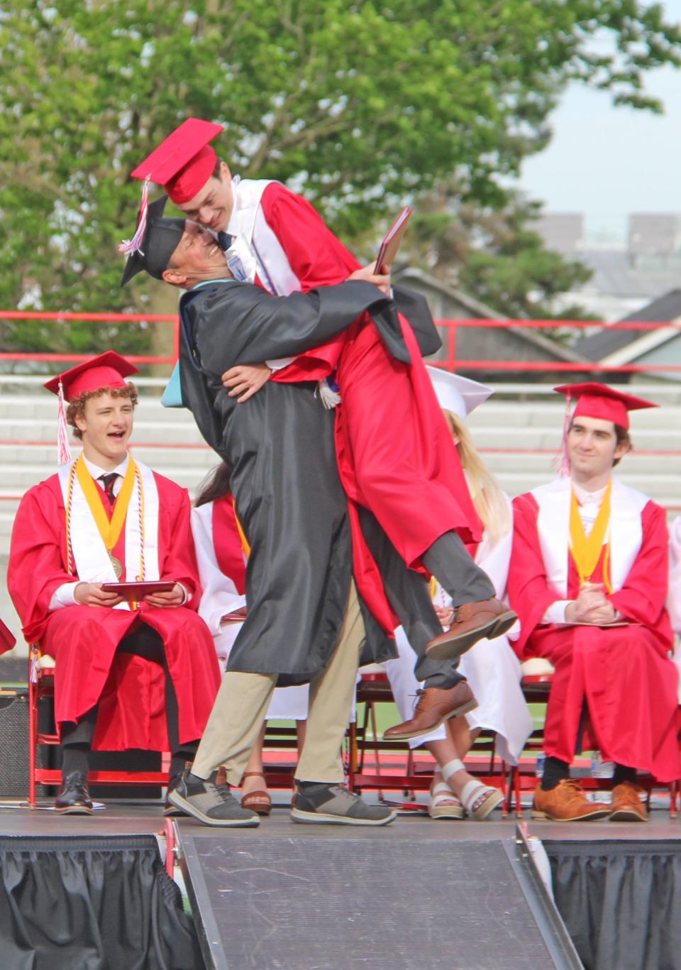 Coldwater teacher Joe Closson embraces his son Joseph Closson after awarding him his diploma Sunday.