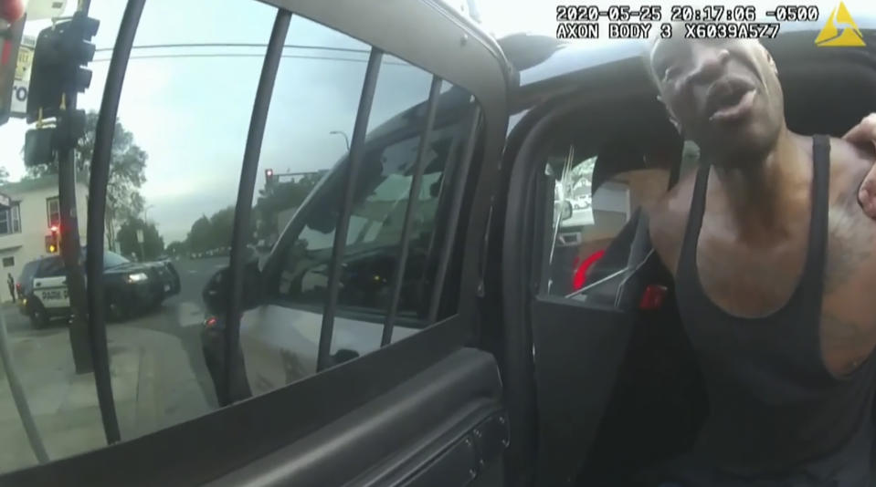 In this image from police body cam video, Minneapolis police officers attempt to place George Floyd in a police vehicle, on May 25, 2020, outside Cup Foods in Minneapolis, as it is shown Wednesday, March 31, 2021, in the trial of former Minneapolis police Officer Derek Chauvin in the death of Floyd, at the Hennepin County Courthouse in Minneapolis. (Court TV via AP, Pool)