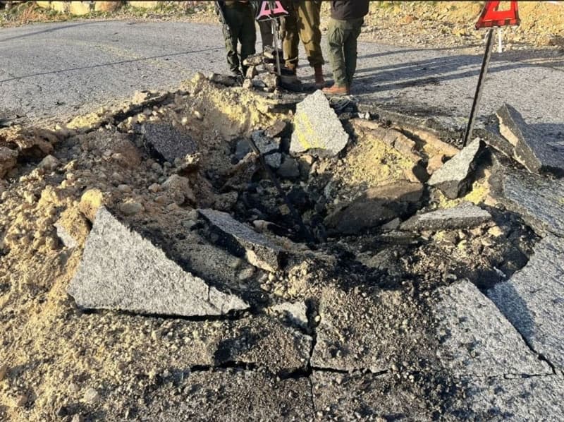 A view of a crater in a road, following an Iranian ballistic missile strike. Israel Defense Forces/ZUMA Press Wire Service/dpa