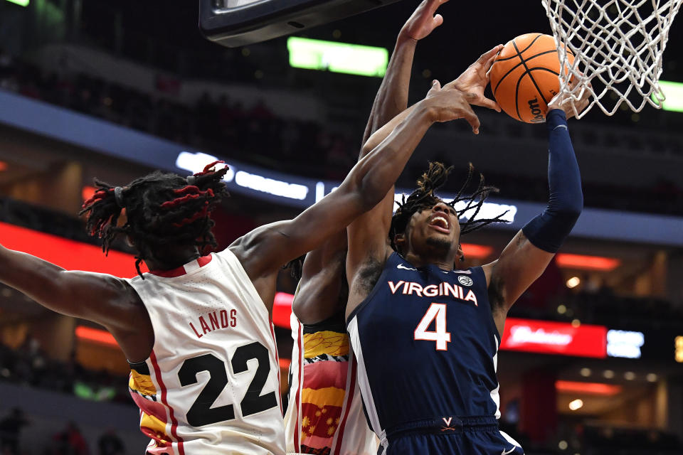 Virginia guard Armaan Franklin (4) is fouled by Louisville forward Kamari Lands (22) during the first half of an NCAA college basketball game in Louisville, Ky., Wednesday, Feb. 15, 2023. (AP Photo/Timothy D. Easley)