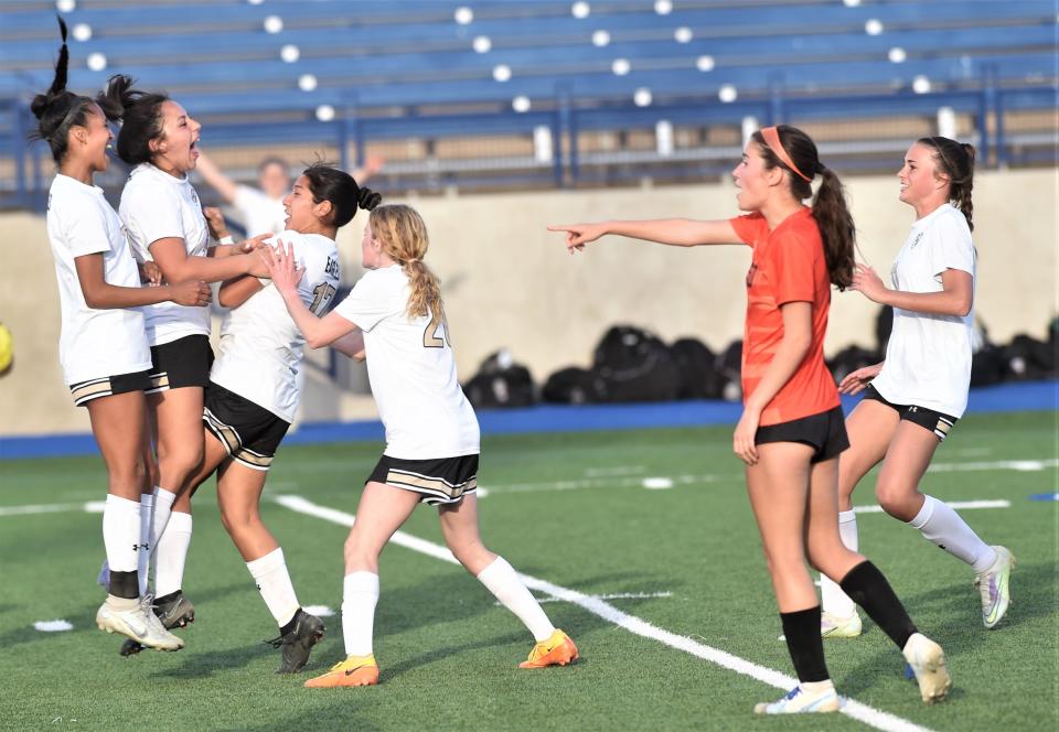 Abilene High players celebrate with Justine Martinez, near left, after goal put the Lady Eagles up 3-1 with 15:02 left in the second half against El Paso High.