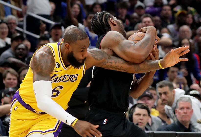 Los Angeles, CA - April 05: Lakers forward LeBron James gets tangled up with Clippers forward Kawhi Leonardhin the third quarter Tuesday night, Apr. 5, 2023, at Crypto.com Arena. (Luis Sinco / Los Angeles Times)