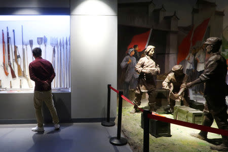 A man looks at exhibits at a 'red tourism' site featuring Chinese Communism, in Shazhou village, Rucheng county, Hunan province, China December 3, 2018. Picture taken December 3, 2018. REUTERS/Shu Zhang