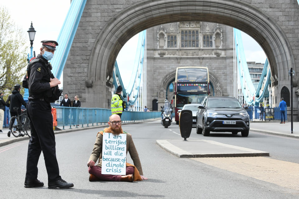 Extinction Rebellion (XR) handout photo of Morgan Trowland, 38, blocking traffic on Tower Bridge in London, as hundreds of people are staging 