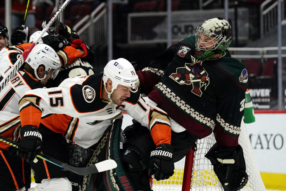 Anaheim Ducks center Ryan Getzlaf (15) hits Arizona Coyotes goaltender Darcy Kuemper (35) in the first period during an NHL hockey game, Monday, Feb. 22, 2021, in Glendale, Ariz. (AP Photo/Rick Scuteri)