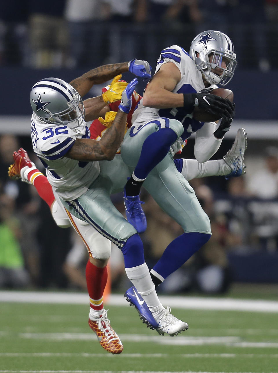 <p>Dallas Cowboys safety Jeff Heath (38) intercepts a pass in front of Orlando Scandrick (32) intended for Kansas City Chiefs tight end Travis Kelce, rear, in the second half of an NFL football game, Sunday, Nov. 5, 2017, in Arlington, Texas. (AP Photo/Brandon Wade) </p>