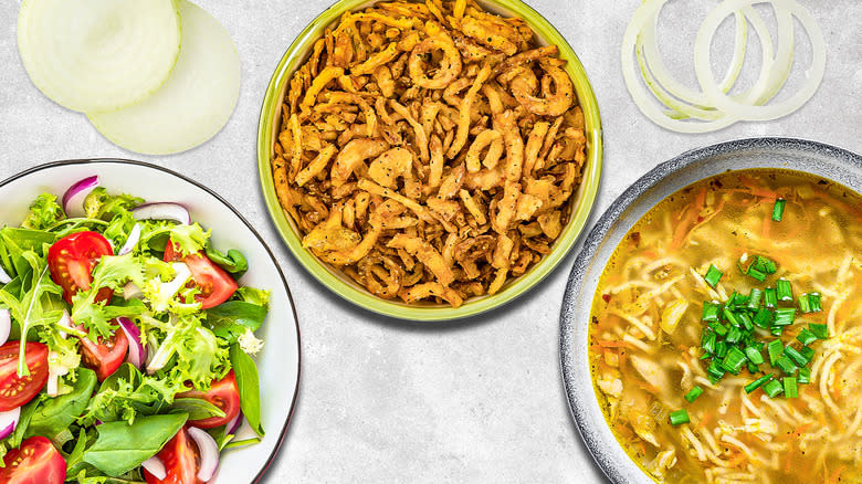 bowl of fried onions between a bowl of soup and a salad