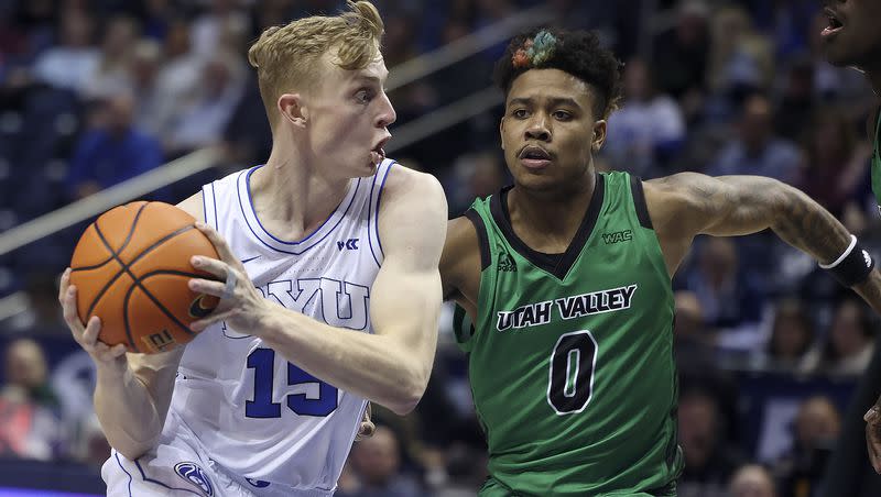 BYU guard Richie Saunders drives past Utah Valley’s Justin Harmon at the Marriott Center in Provo on Wednesday, Dec. 7, 2022.